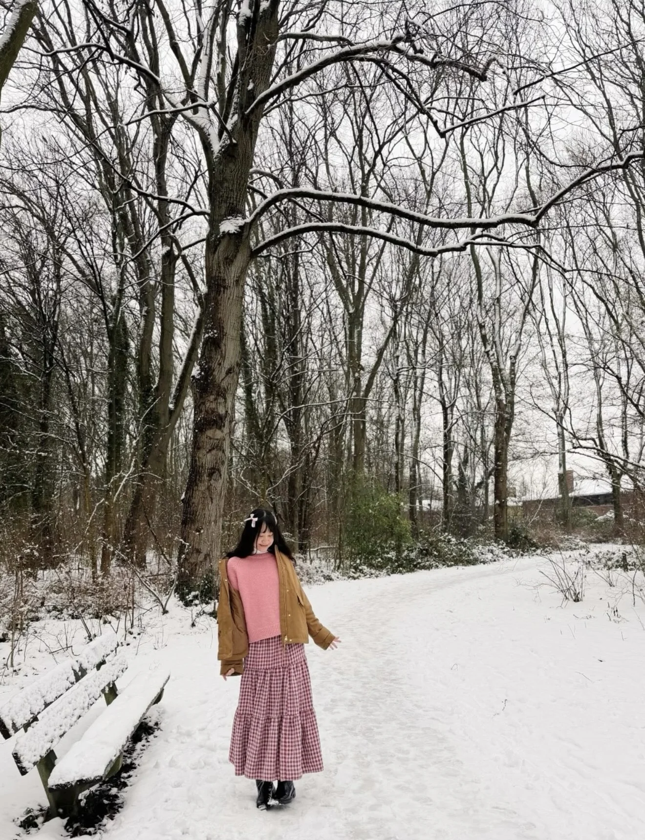 Lan walking on a snowy forest path
