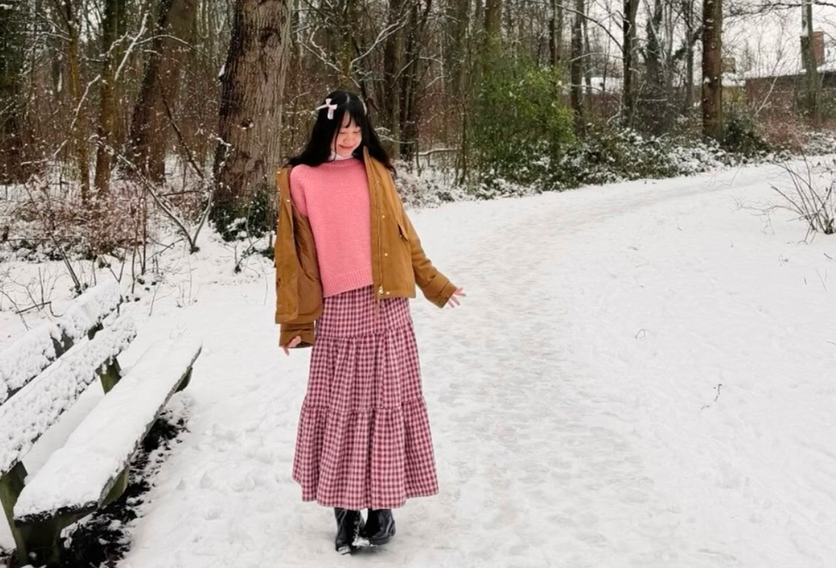 Lan walking through a snowy forest in the Netherlands